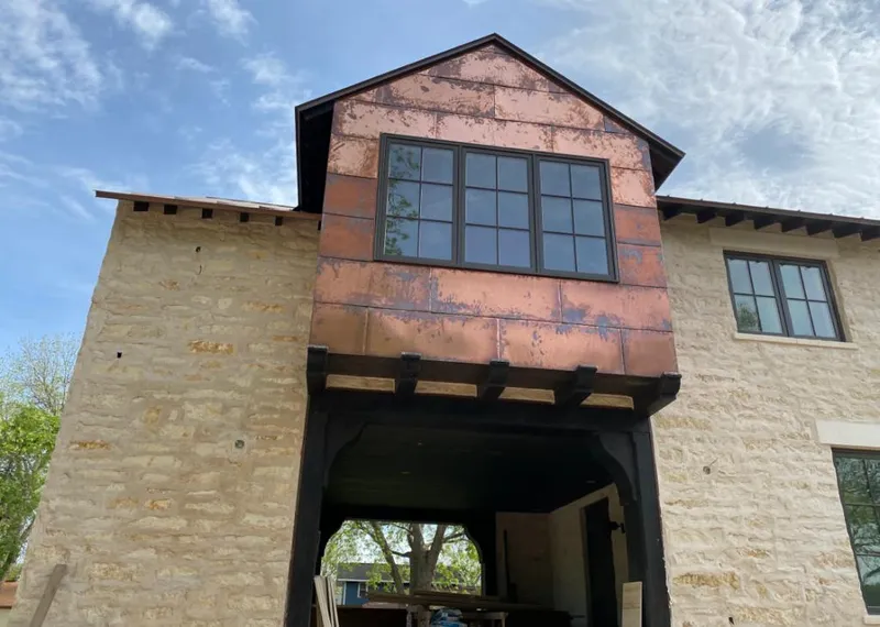 Copper metal panel facade on a stone building for Metal Roof Coating in Frisco