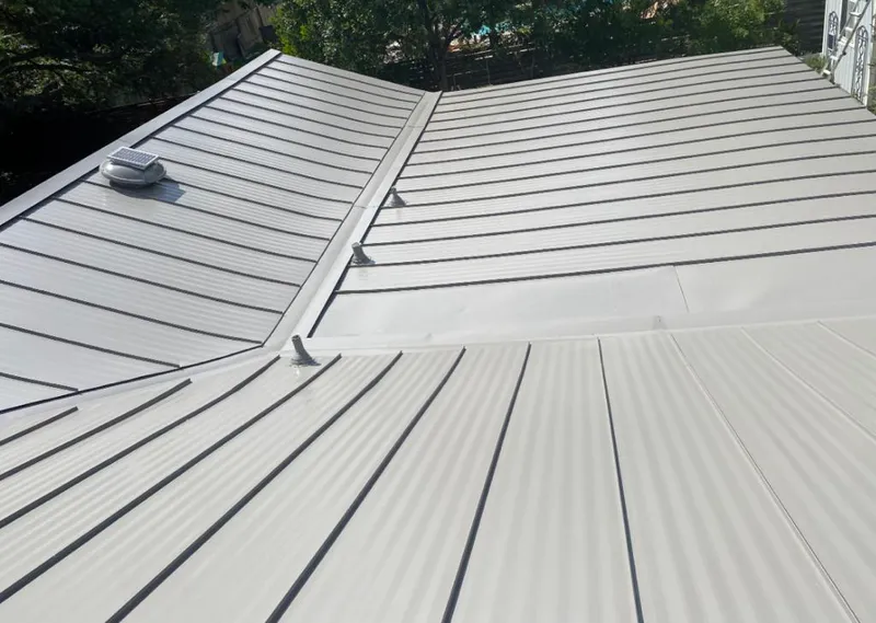 Solar attic fan installed on a metal roof for Roof Ventilation in Frisco